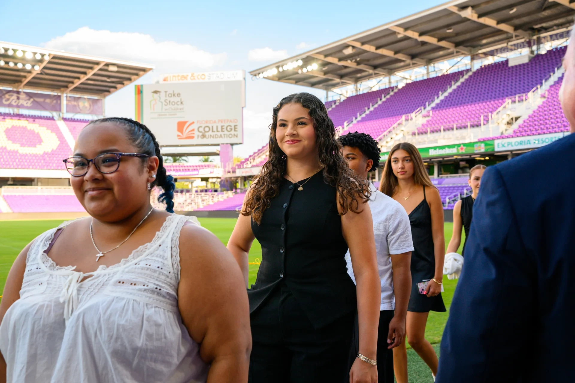 Scholarship students walking the field at Inter&Co Stadium during a Florida Prepaid College Foundation ceremony in Orlando