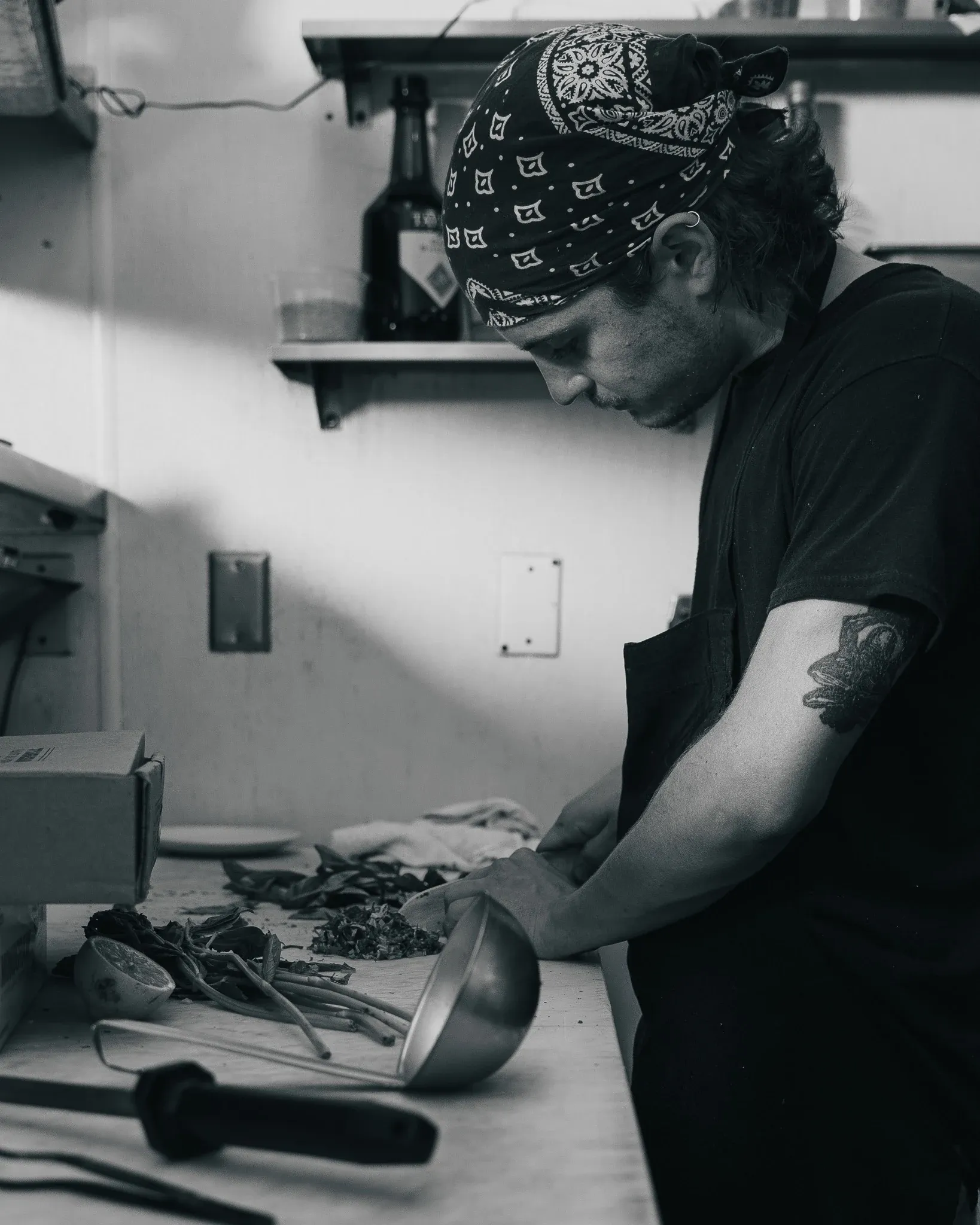 Sous chef chopping herbs at Collage restaurant