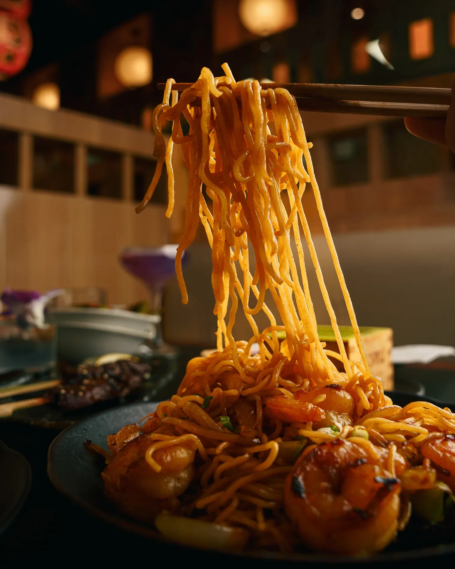 Stir-fried noodles and shrimp with a dramatic noodle pull from chopsticks