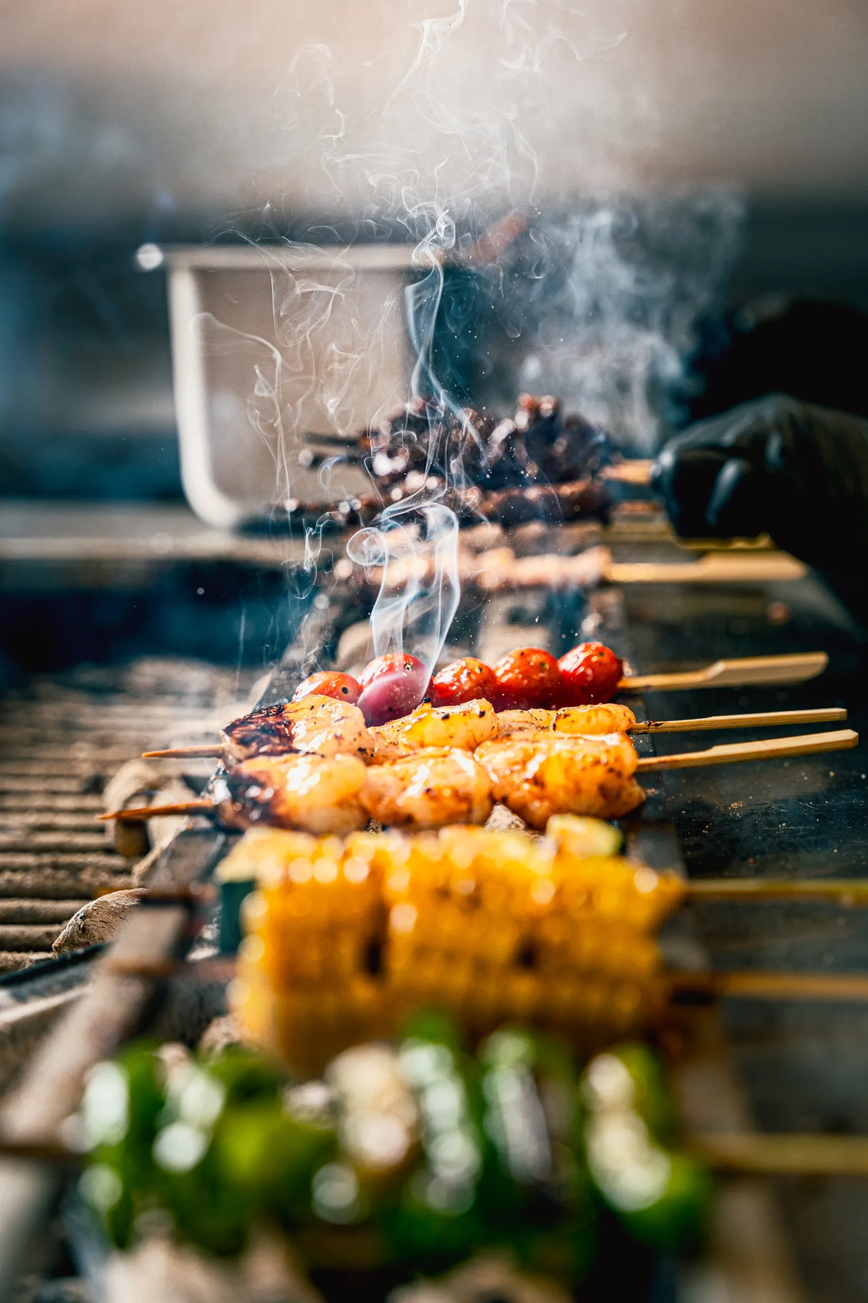 Yakitori skewers with shrimp and vegetables in smoke