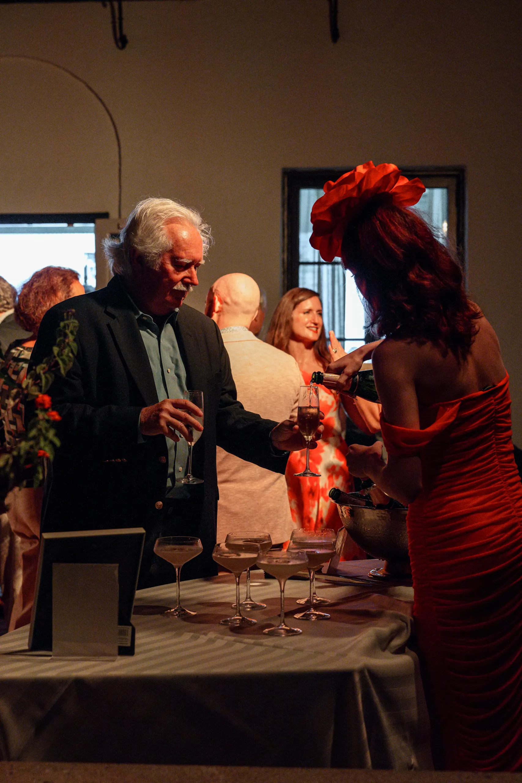 Topping off champagne to celebrate at the San Marco Centennial Soirée