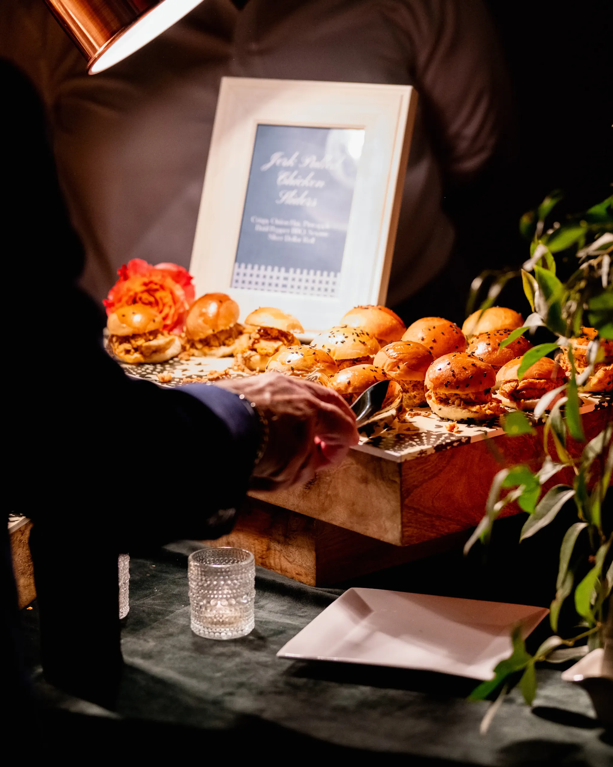 Gentleman enjoying slider at the San Marco Centennial Soirée