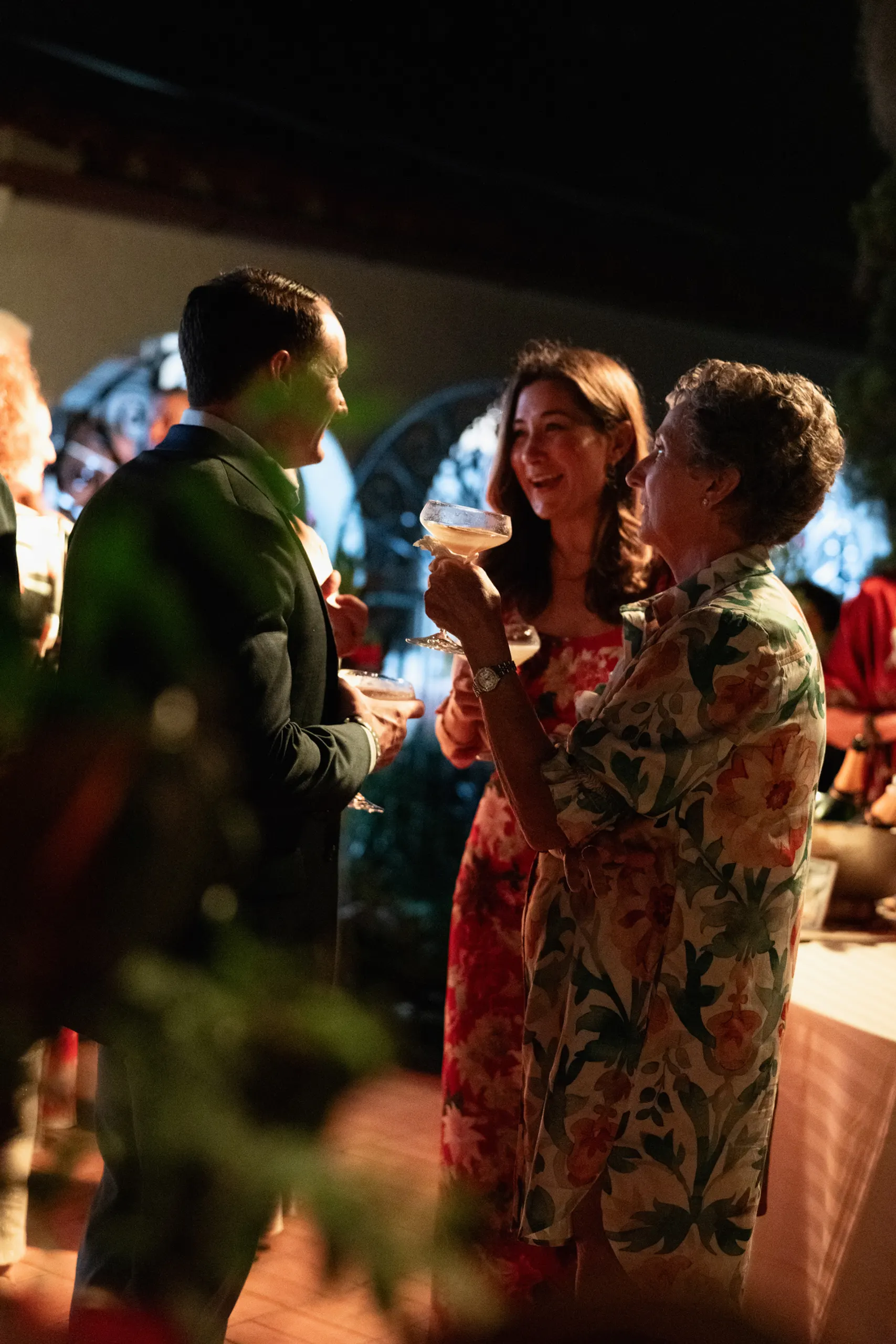Couple laughing over drinks at the San Marco Centennial Soirée