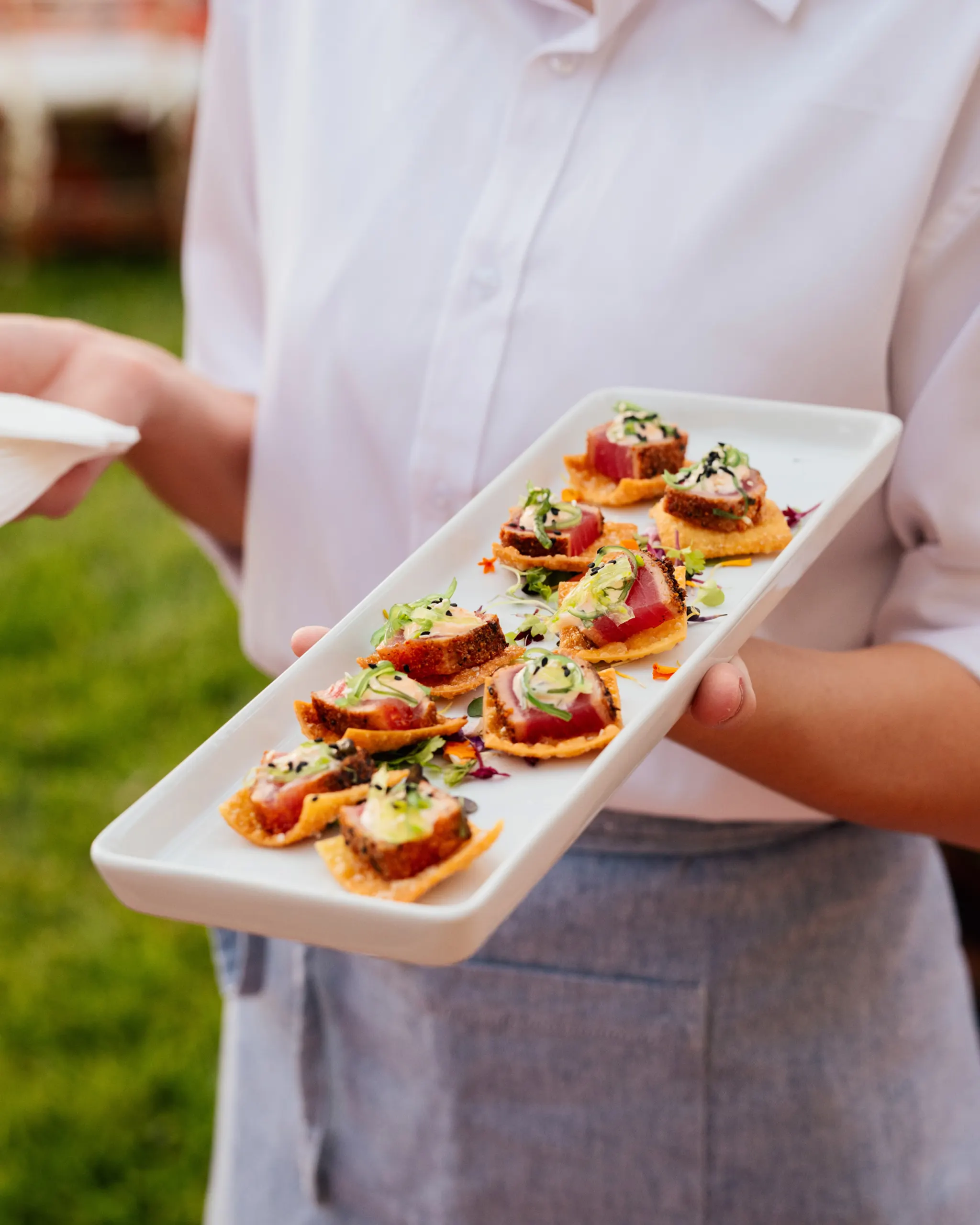 Salmon sashimi on crispy wontons with garnish at the San Marco Centennial Soirée