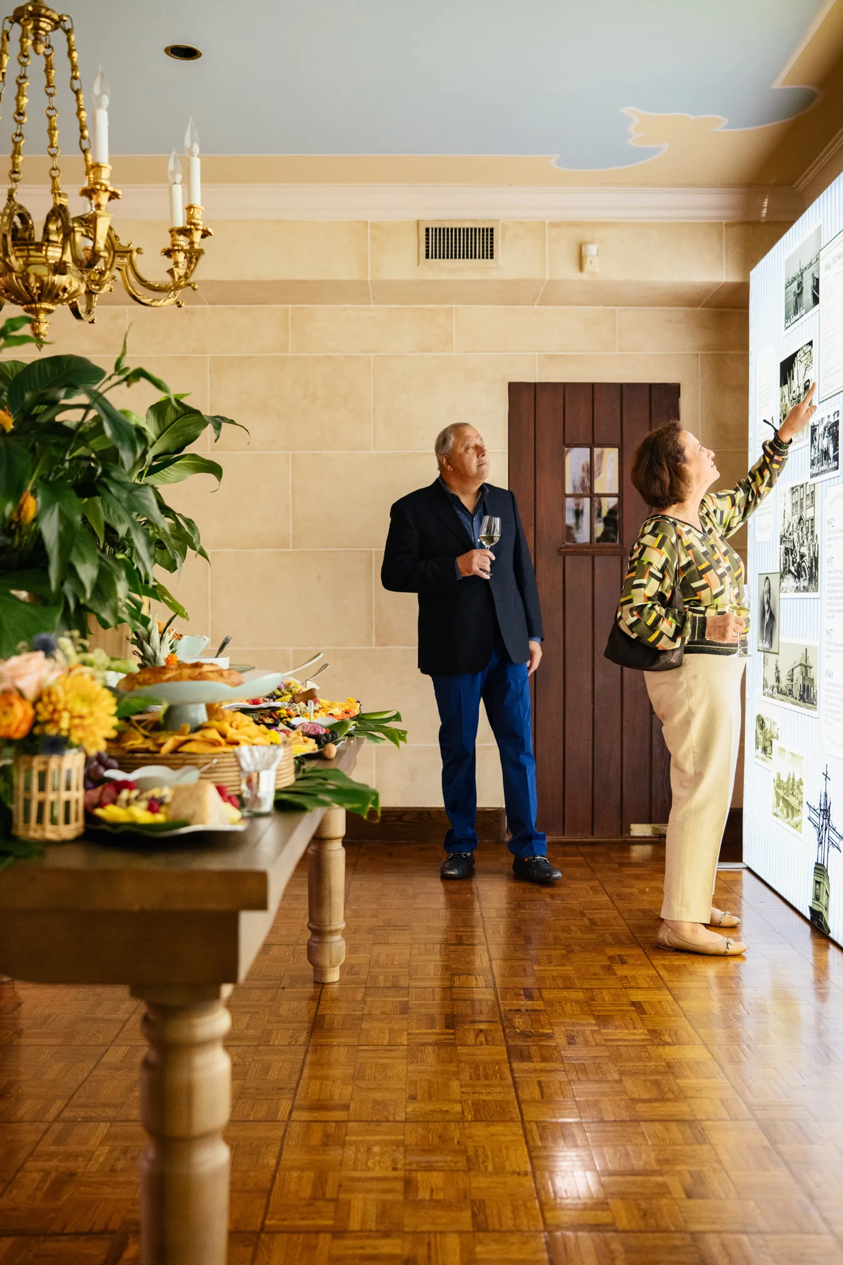 Jack Hanania and wife admiring timeline wall at the San Marco Centennial Soirée